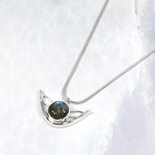 Load image into Gallery viewer, the labradorite Faye necklace evokes the new moon and gliding wings. The deep blue labradorite cabochon has exceptional dimension and hints of aqua and gold. The detailing detailing on the back makes this piece a 360º treasure.

