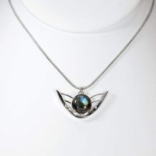 Load image into Gallery viewer, the labradorite Faye necklace evokes the new moon and gliding wings. The deep blue labradorite cabochon has exceptional dimension and hints of aqua and gold. The detailing detailing on the back makes this piece a 360º treasure.
