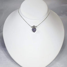 Load image into Gallery viewer, With its curling vines and hand textured petal, the Fleur necklace adds a touch of romance to your look. The checker cut Lilac Chalcedony has a soft purple glow and just the right amount of sparkle.
