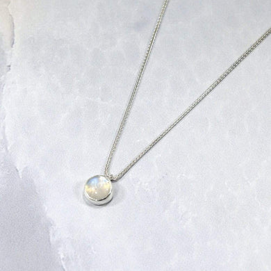 This 11mm Luna necklace features a beautiful round Rainbow Moonstone simply set in a smooth silver bezel. A silver wheat chain completes the clean, classic look you will find yourself wearing over and over.