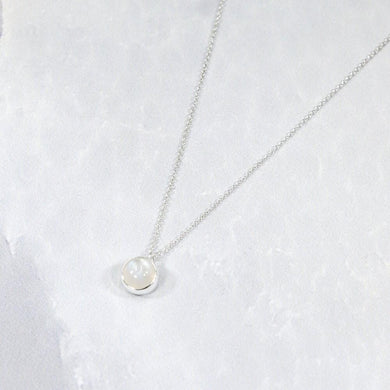This 9mm Luna necklace features a beautiful round Rainbow Moonstone simply set in a smooth silver bezel. A simple oval chain completes the clean, classic look you will find yourself wearing over and over.