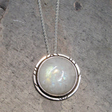 Load image into Gallery viewer, Mona is a charming moonstone pendant surrounded by a delicate shadowbox with geometric details. A hidden bail makes her appear to float on the delicate wheat chain.
