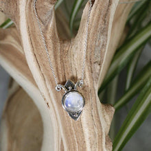 Load image into Gallery viewer, Hand-shaped silver tendrils allow this Fleur pendant to glide along its dainty oval chain. A narrow round bezel band and silver pebbles accent the violet-blue flash of the Moonstone.
