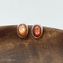 Load image into Gallery viewer, These Sunstone earrings are ﻿simple and sweet but not shy with their beautiful shimmery reddish-orange hue!  Details:  Solid sterling silver, partially recycled  Sunstone  Earring faces: 9mm x 7mm Surgical Steel butterfly backings
