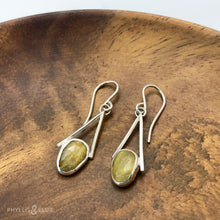 Load image into Gallery viewer, Rosecut Quartz with golden hued crystalline inclusions are suspended in an airy, asymmetrical frame  Details:  Solid sterling silver, partially recycled  Dendritic Quartz  Earring faces: 11mm x 23mm  Sterling silver ear hooks
