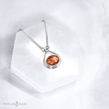 Load image into Gallery viewer, A shimmering orange Sunstone set in a silver bezel and nestled in an elegant and minimalist teardrop halo.   Solid sterling silver, partially recycled  Sunstone  Pendant 17mm x 20mm 16” long Sterling Silver chain plus 2&quot; Extension  Lobster claw clasp
