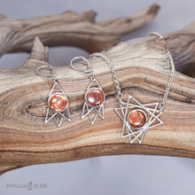 Load image into Gallery viewer, Shimmering Sunstone cabochons flanked by silver openwork rays and suspended from elegant lever-back ear hooks  Solid sterling silver, partially recycled  Sunstone  Earring faces: 15mm x 30mm  Sterling silver ear hooks
