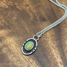 Load image into Gallery viewer, A super flashy Ethiopian Opal wrapped in a silver bezel is framed by a slim patinated shadowbox and hand carved details.   Details:  Solid sterling silver, partially recycled  Ethiopian Opal  Pendant: 10mm x 17mm  16” long Sterling Silver chain plus 2&quot; extension  Lobster-claw clasp
