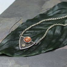 Load image into Gallery viewer, A shimmering Sunstone rises through the thick silver frame of its shadowbox. A faceted golden Topaz adds even more color and sparkle to this striking pendant.  Details  Solid sterling silver, partially recycled  Sunstone &amp; Golden Topaz  Pendant: 28mm x 23mm  18” long Sterling Silver chain plus 2&quot; extension  Lobster-claw clasp
