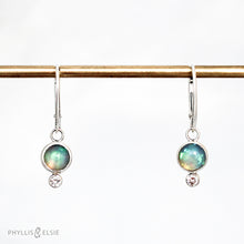 Load image into Gallery viewer, Sweet dewdrops of Ethiopian Opals glow with shades of blue, green, and peach. White Sapphires at an extra touch of sparkle and elegant lever-back ear hooks keep your earrings secure with extra style.  Details  Solid sterling silver, partially recycled  Ethiopian Opal, White Sapphire  Earring face: 8mm x 15mm  Sterling lever-back hooks
