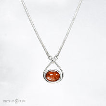 Load image into Gallery viewer, A shimmering orange Sunstone set in a silver bezel and nestled in an elegant and minimalist teardrop halo.   Details  Solid sterling silver, partially recycled  Sunstone  Pendant 17mm x 20mm  16” long Sterling Silver chain plus 2&quot; Extension  Lobster claw clasp
