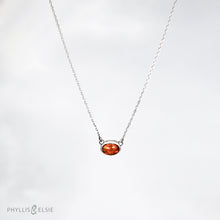 Load image into Gallery viewer, Evie brings the perfect tiny highlight to your look. The lovely Ethiopian Opal shows flashes of hot pink, orange, and green in a soft orange base. It and is nestled in a delicate diamond-cut sterling silver chain for extra sparkle.  Details  Solid sterling silver, partially recycled  Ethiopian Opal   Pendant 10mm X 6mm  16” long Sterling Silver chain  Lobster claw clasp
