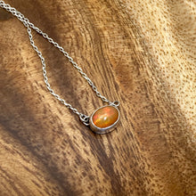 Load image into Gallery viewer, Evie brings the perfect tiny highlight to your look. The lovely Ethiopian Opal shows flashes of hot pink, orange, and green in a soft orange base. It and is nestled in a delicate diamond-cut sterling silver chain for extra sparkle.  Solid sterling silver, partially recycled  Ethiopian Opal   Pendant 10mm X 6mm  16” long Sterling Silver chain  Lobster claw clasp

